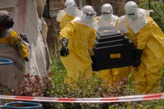 A-woman-cries-as-Red-Cross-workers-carry-the-coffin-of-a-person-who-died-of Ebola-from-a-health center-in-Rwampara,-Congo,-Wednesday, May-20,-2026