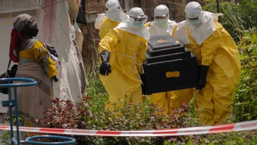 A-woman-cries-as-Red-Cross-workers-carry-the-coffin-of-a-person-who-died-of Ebola-from-a-health center-in-Rwampara,-Congo,-Wednesday, May-20,-2026